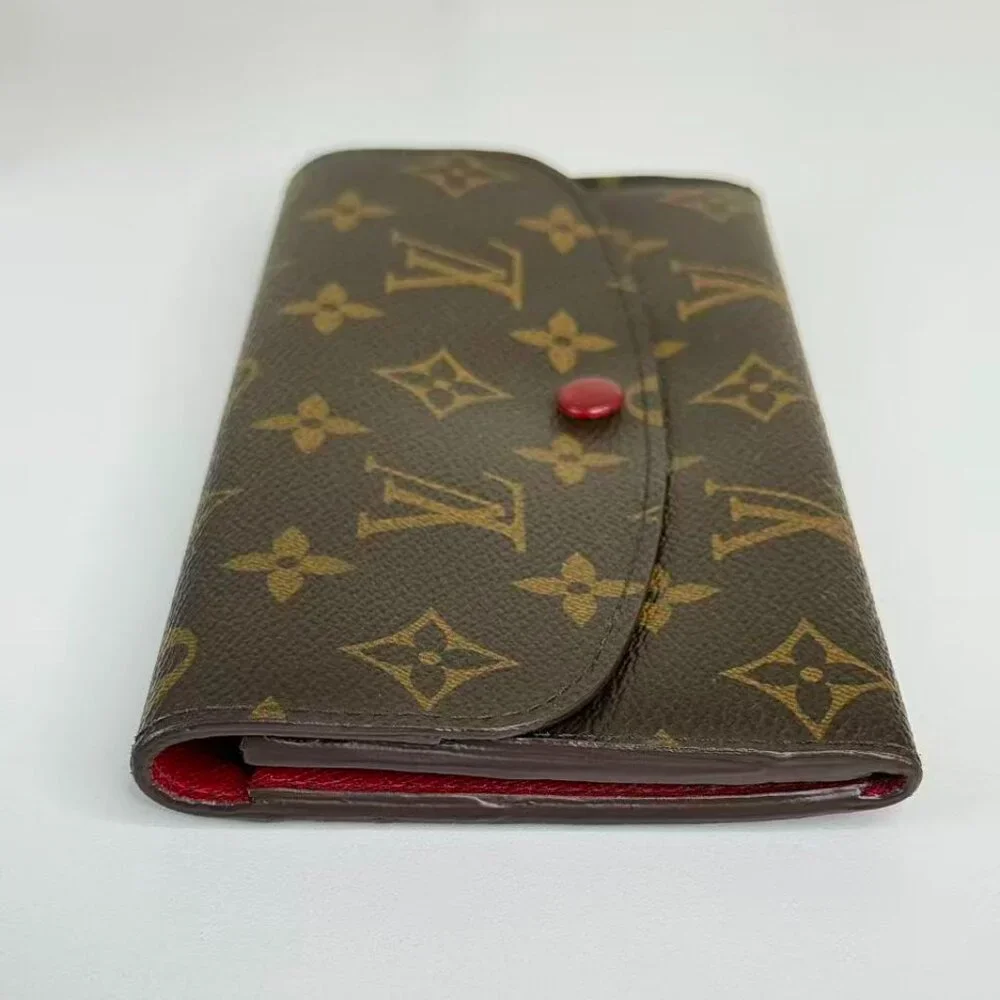 Louis Vuitton Monogram Canvas Wallet with Classic Design and Red Pin Detail